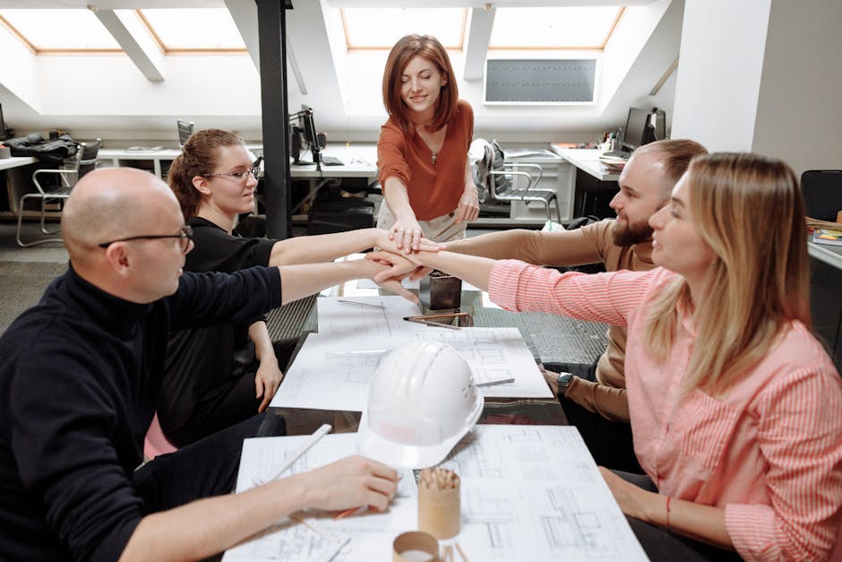 Architects collaborate on project plans in a modern office setting.